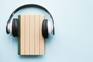 Headphones,And,Paper,Book,On,Blue,Background.,Audiobook,Concept.,Top
